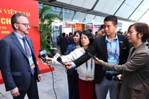 Các phóng viên, nhà báo tác nghiệp tại Trung tâm Báo chí Đại hội XIV của Đảng