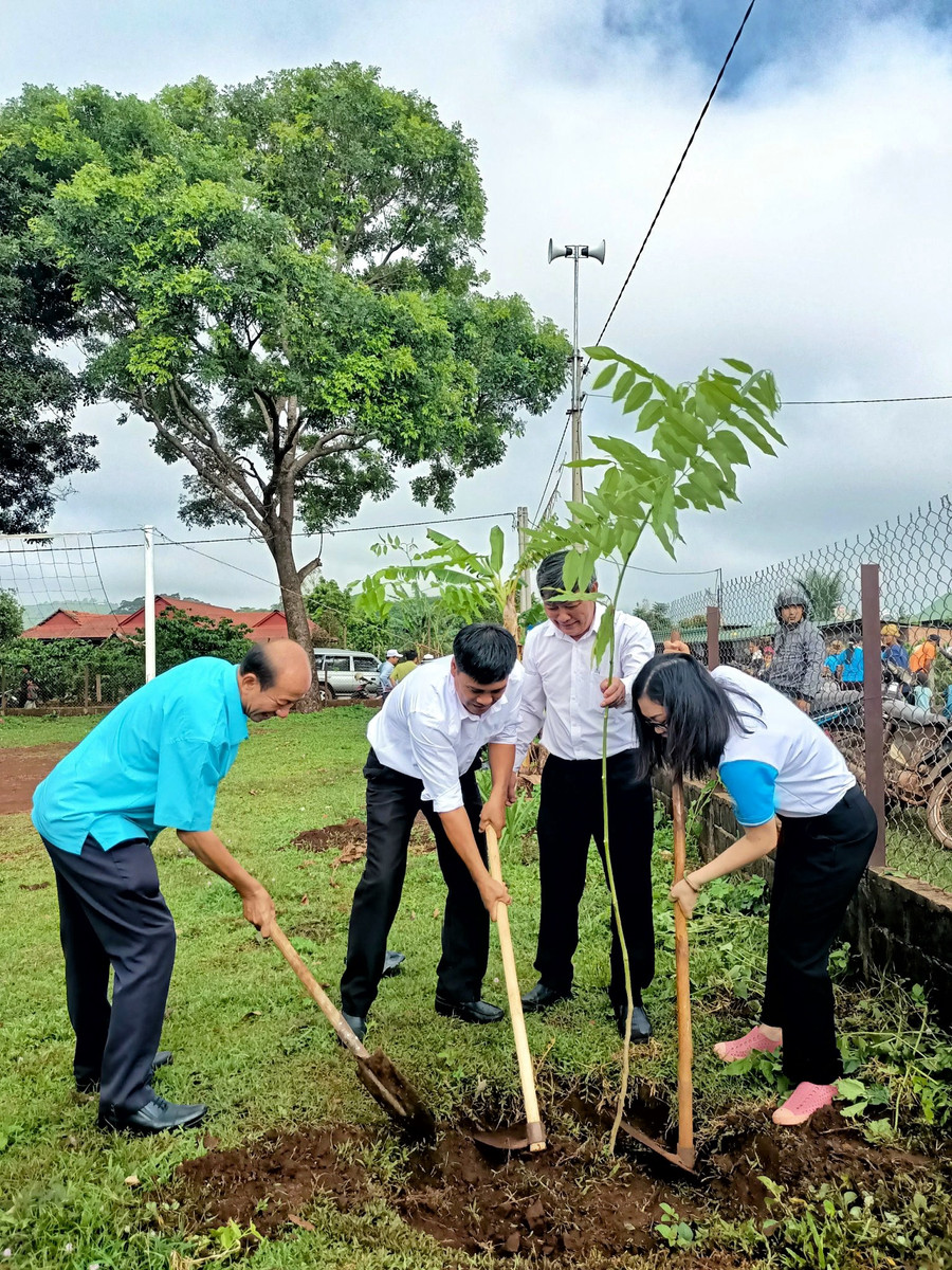 Trồng cây trong khuôn viên nhà rông làng Kép 1. Ảnh: Minh Châu