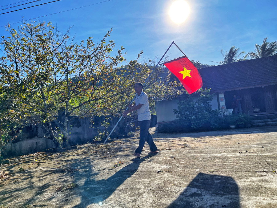 Chỉ cần thấy mai vàng nở rộ nơi góc sân, treo lá cờ Tổ quốc trước ngõ, ông Đường thấy như xuân đã tràn ngập trong nhà, ngoài ngõ. Ảnh: Hoàng Ngọc