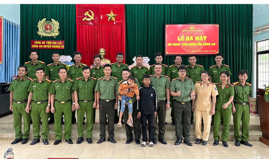 Ban Chỉ đạo mô hình &quot;Con nuôi Công an&quot; chụp hình cùng 2 cháu Ksor Kưới, Ksor Viên. Ảnh: Quang Ngọc