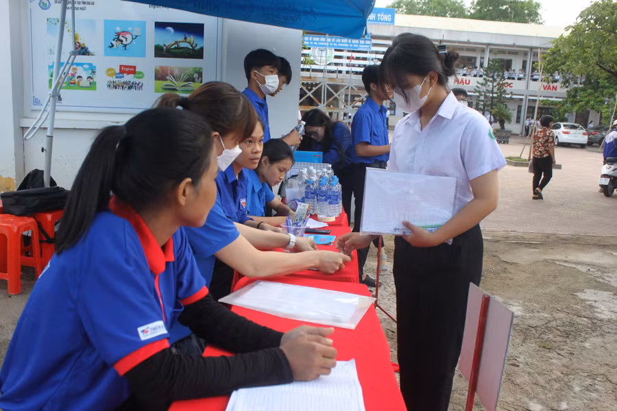 Các tình nguyện viên tại điểm thi Lê Thánh Tông (thị xã Ayun Pa) hỗ trợ thí sinh bảo quản đồ đạc khi vào phòng thi. Ảnh: Vũ Chi