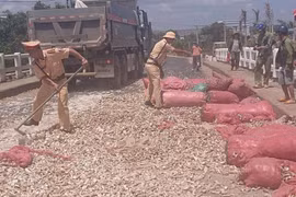 Cảnh sát Giao thông Phú Thiện giúp dân dọn dẹp mì rơi vãi trên quốc lộ