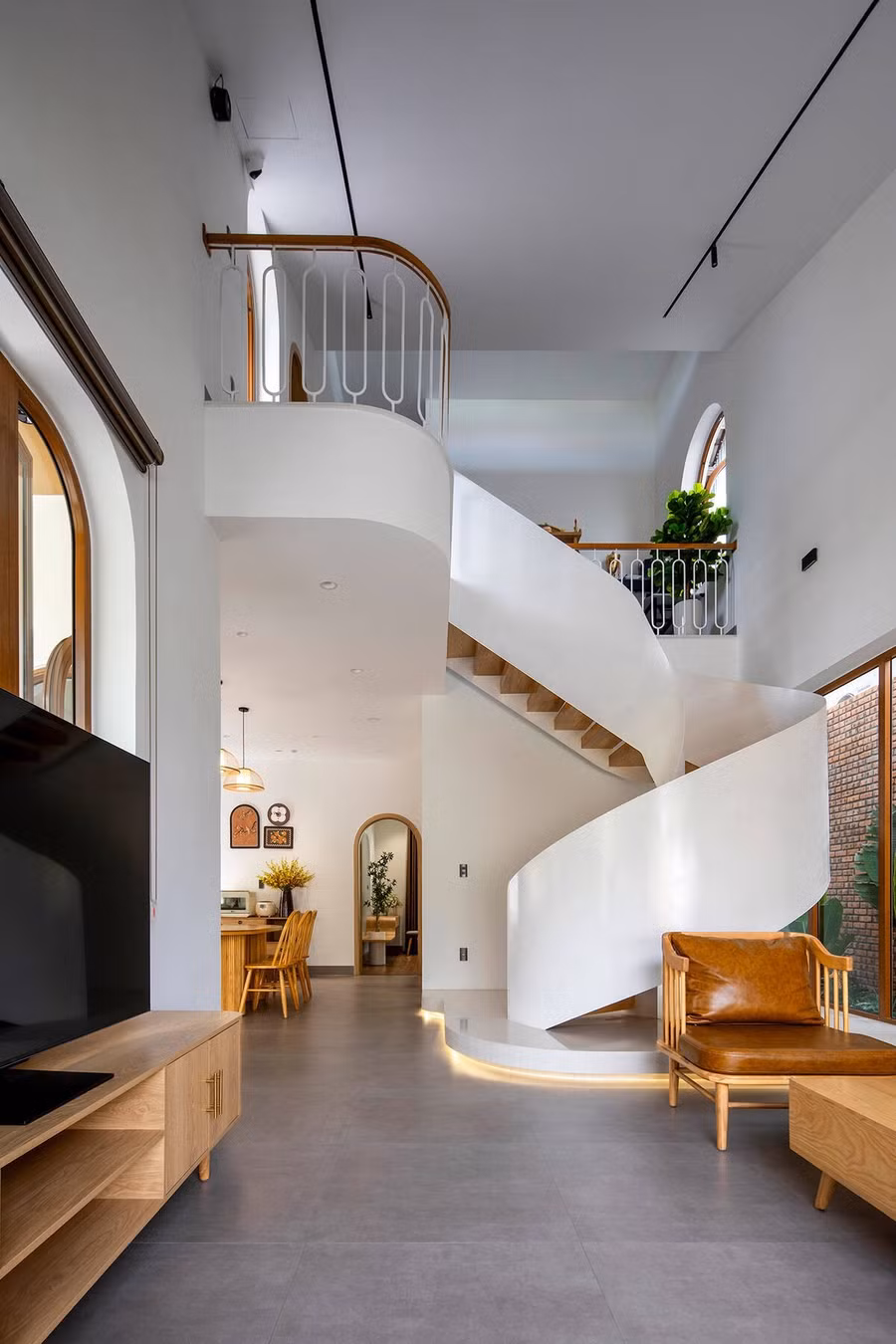 Điểm nhấn kiến trúc nổi bật của ngôi nhà là cầu thang xoắn trắng tinh