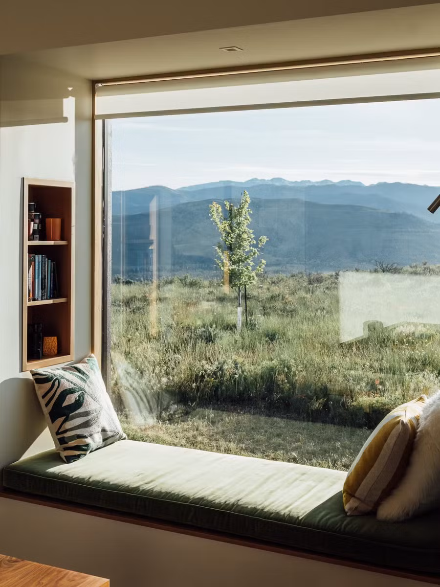 Một chiếc bàn nhỏ và bục mở rộng bên cửa sổ là nơi để gia chủ làm việc, đọc sách hoặc ngồi thư giãn.