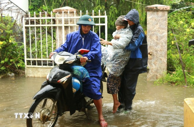 Lực lượng chức năng phường Xuân Đài, tỉnh Đắk Lắk hỗ trợ di dời người đến nơi an toàn để tránh bão số 13. (Ảnh: Tường Quân/TTXVN)