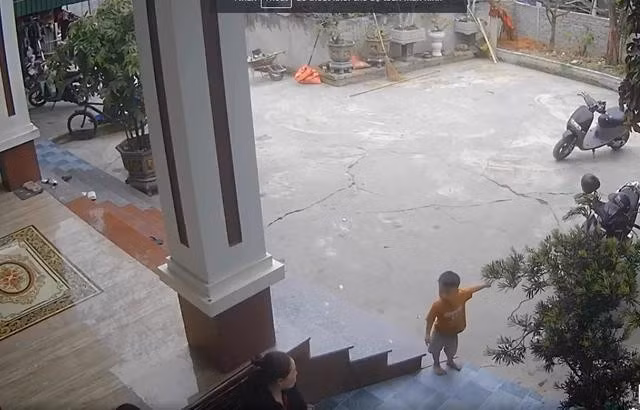 Thấy mẹ chưa hiểu chuyện, bé Nam Phong vừa kêu, vừa chỉ tay ra hướng cổng nhà. ẢNH: CẮT TỪ VIDEO