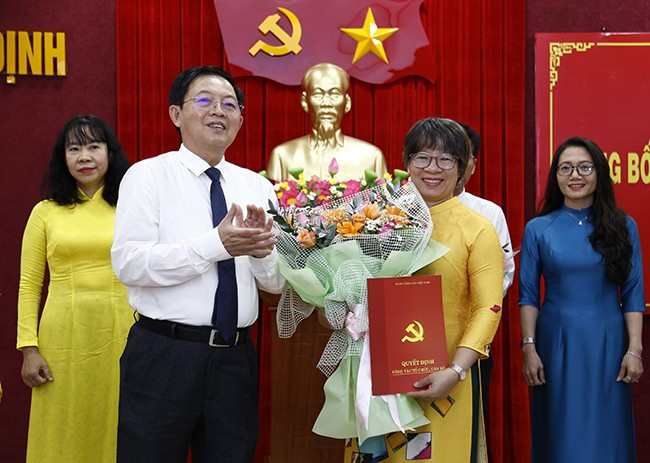 Bí thư Tỉnh ủy Hồ Quốc Dũng trao quyết định bổ nhiệm, tặng hoa chúc mừng đồng chí Nguyễn Thị Bích Sương - Phó Tổng Biên tập Báo Bình Định, giữ chức Phó Tổng Biên tập Báo Bình Định sau hợp nhất. Ảnh: HỒNG PHÚC 4b.jpg