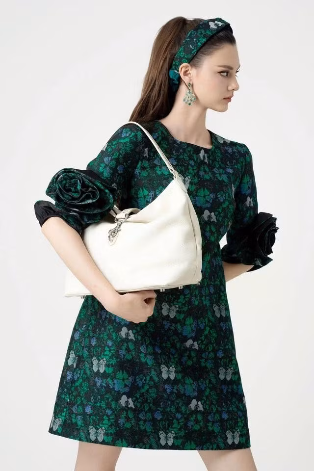 Váy dáng ngắn, kiểu babydoll xanh lá với họa tiết sáng màu mang đến vẻ khỏe khoắn, thời thượng và sành điệu mang đến những năng lượng mạnh mẽ cho không gian văn phòng. ẢNH: VALENCIANI