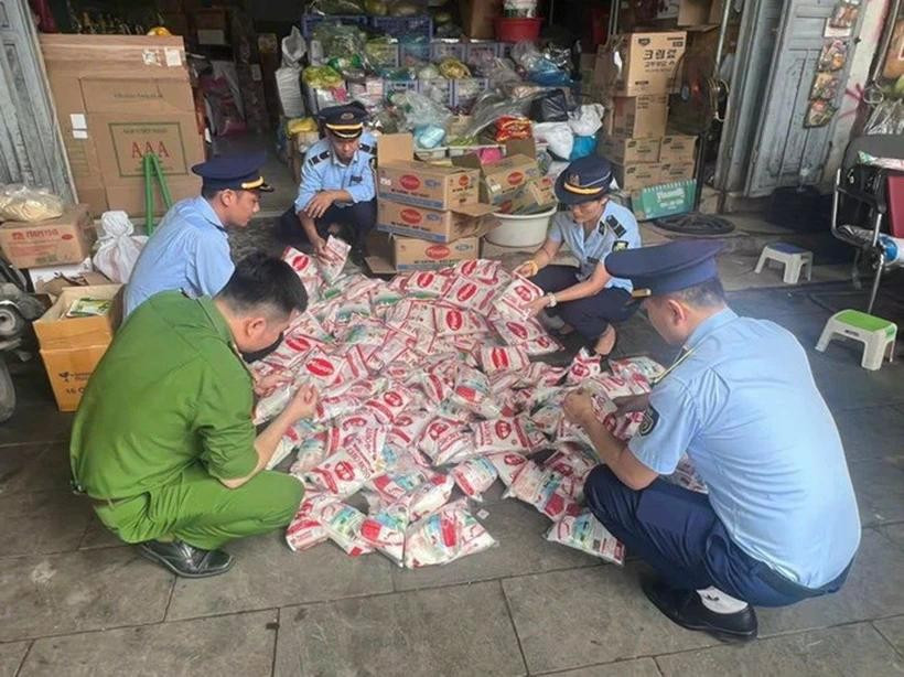 Lực lượng chức năng kiểm tra số mì chính có dấu hiệu giả mạo, không rõ nguồn gốc tại một hộ kinh doanh ở chợ Vinh. Ảnh: Báo Hà Tính nghean.jpg