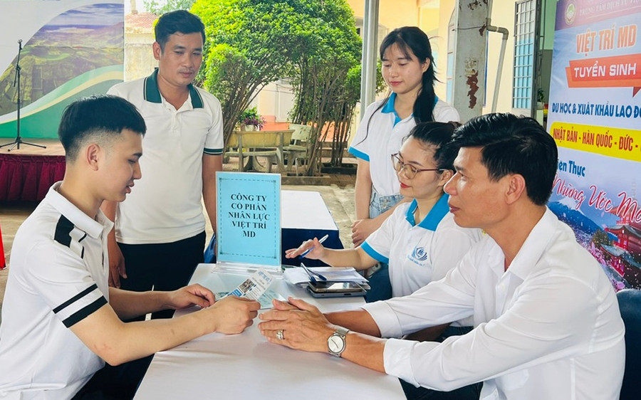 Ông Nguyễn Văn Đức (bìa phải)-Giám đốc Công ty Việt Trí MD (TP. Pleiku) tư vấn cho người lao động về chương trình du học sinh tại Nhật Bản. Ảnh: Đ.Y yen.jpg