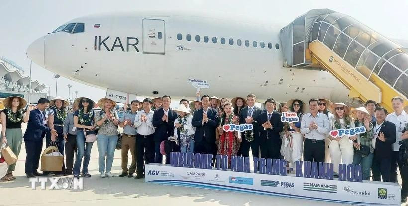 Du khách Nga chụp ảnh lưu niệm sau khi đặt chân đến sân bay quốc tế Cam Ranh. Ảnh: Tiên Minh/TTXVN du-khach-nga.jpg