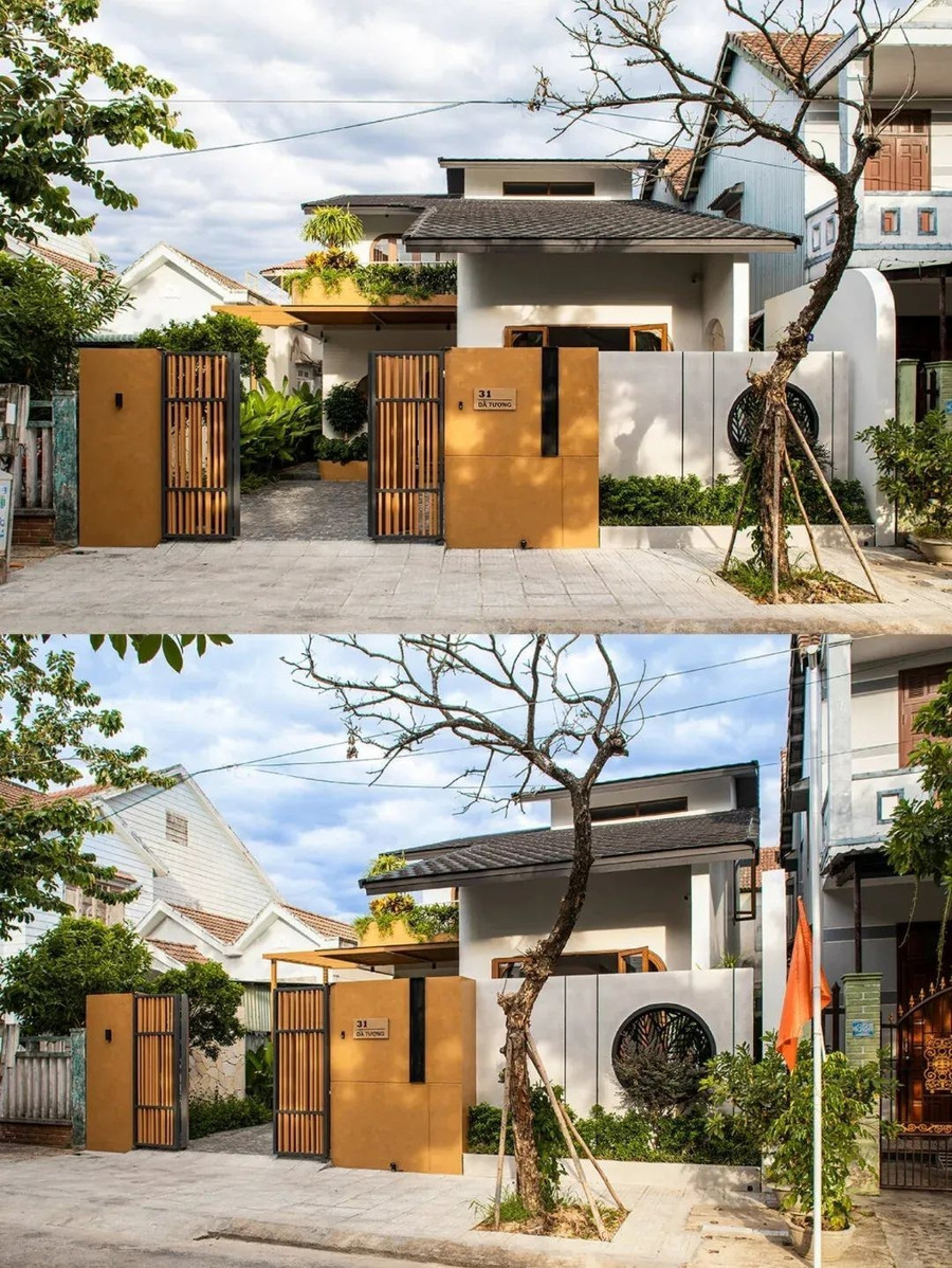 Mặt tiền gây ấn tượng với tông terracota ấm áp và những ô cửa tròn hiện đại.
