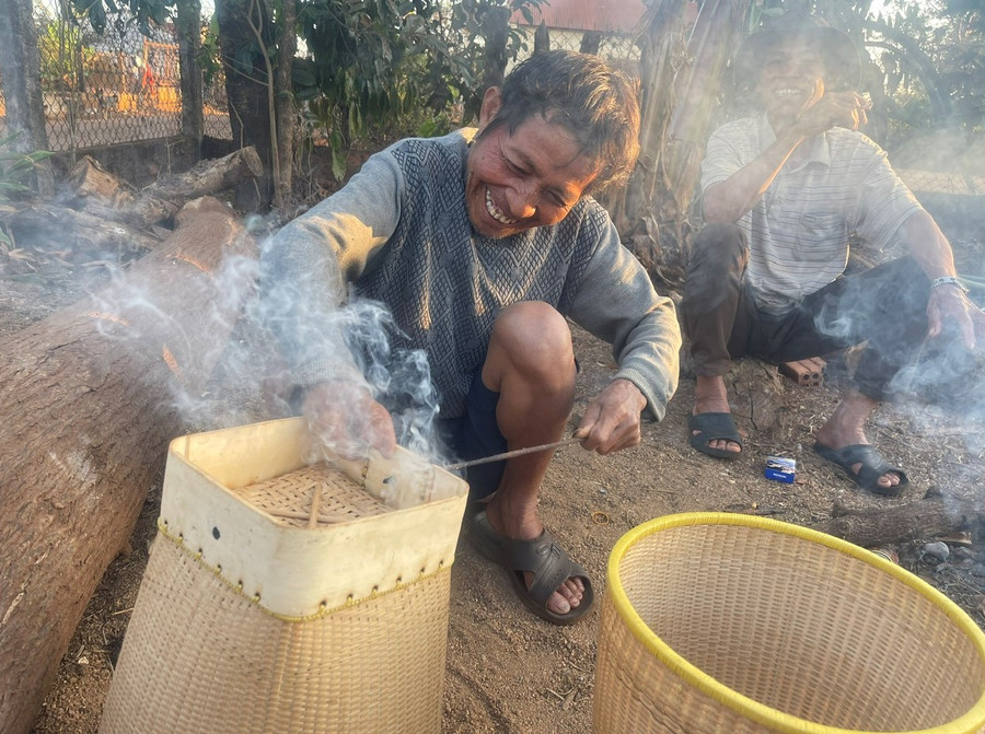 Ông Na đang tạo những chiếc lỗ nơi đế gùi để luồn dây đeo. Ảnh: P.D Ông Na đang tạo những chiếc lỗ nơi đế gùi để luồn dây đeo. Ảnh: P.D