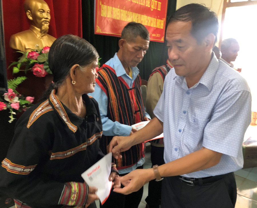 Đại diện Đảng ủy Khối các Cơ quan và Doanh nghiệp tỉnh tặng quà của Chi bộ 2 cho các hộ nghèo, gia đình chính sách của làng C. Ảnh: Anh Huy Đại diện Đảng ủy Khối các Cơ quan và Doanh nghiệp tỉnh tặng quà của Chi bộ 2 cho các hộ nghèo, gia đình chính sách của làng C. Ảnh: Anh Huy