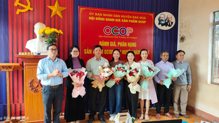 Lãnh đạo UBND huyện Đak Đoa tặng hoa chúc mừng các chủ thể có sản phẩm được công nhận đạt OCOP 3-4 sao cấp huyện .Ảnh: cơ quan chức năng cung cấp