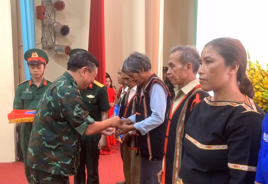 Đại diện đoàn công tác HVQP tặng quà các già làng, trưởng thôn trên địa bàn Binh đoàn 15 đứng chân. Ảnh: T.D