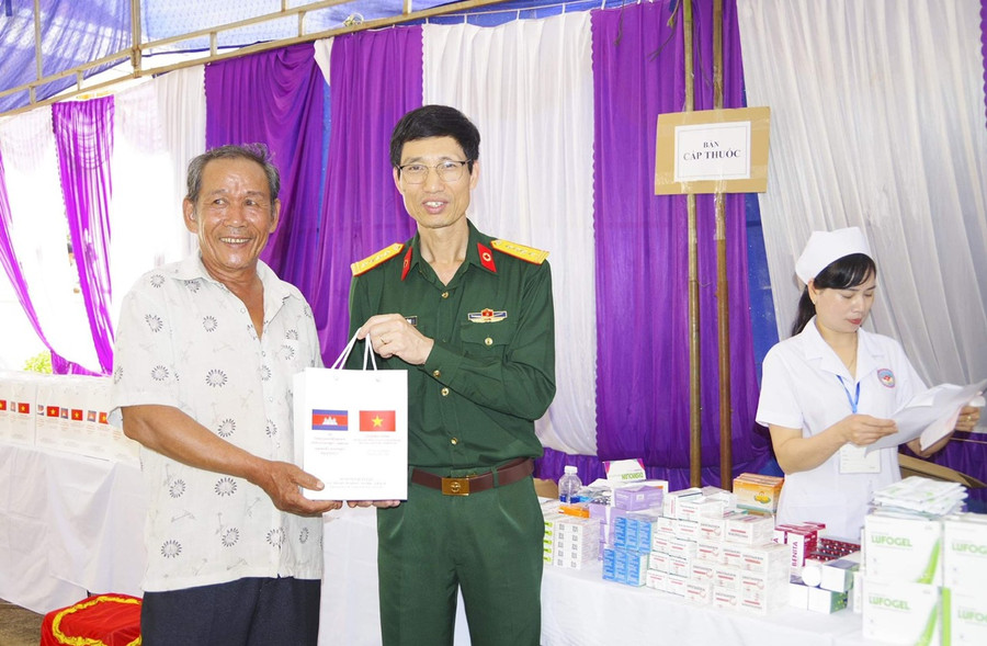 Đại tá Hoàng Tiến Dũng-Giám đốc Bệnh viện Quân y 211 cấp thuốc cho người dân. Ảnh: N.Y