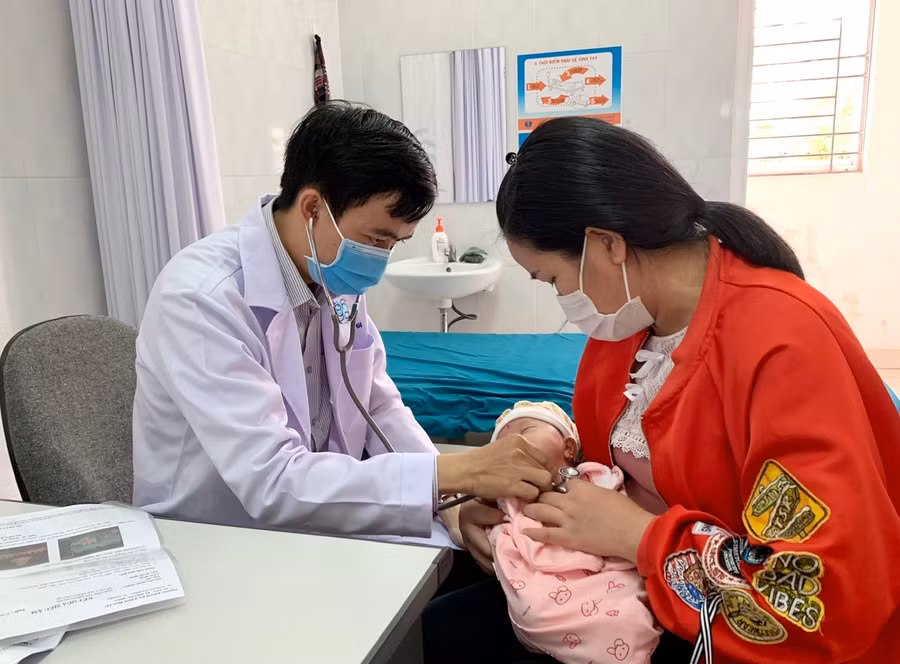 Nhân viên y tế khám sàng lọc sức khỏe cho trẻ trước khi tiêm chủng. Ảnh: Như Nguyện