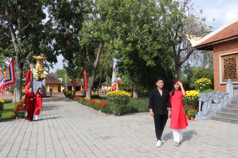 Chị Lê Thị Ngọc Ánh (bìa phải, thôn An Sơn, xã Cư An, huyện Đak Pơ) chọn trang phục áo dài chụp hình lưu niệm tại Khu Di tích lịch sử-văn hóa Tây Sơn Thượng đạo. Ảnh: Ngọc Minh