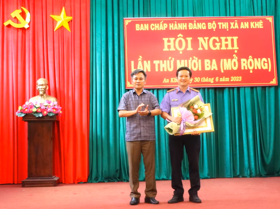 Thừa ủy quyền Ban Chấp hành Đảng bộ Tỉnh Gia Lai, Bí thư Thị ủy An Khê Nguyễn Xuân Phước (bìa trái) trao bằng khen cho tập thể có thành tích. Ảnh: Ngọc Minh