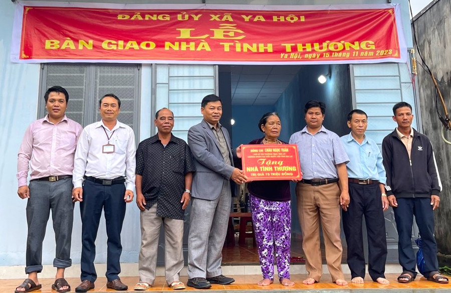 Phó Bí thư Thường trực Huyện uỷ Đak Pơ Nguyễn Trường (thứ 4 từ trái sang) trao “Nhà tình thương” cho bà Đinh Thị Đuênh. Ảnh: Nguyễn Hiền