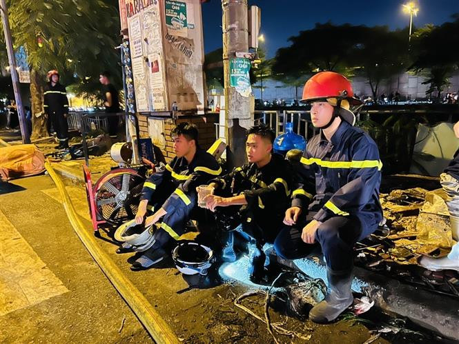 Các chiến sĩ cảnh sát PCCC&amp;CNCH tranh thủ nghỉ ngơi sau nhiều giờ chiến đấu với giặc lửa trong vụ cháy quán karaoke ở phố Quan Hoa, Cầu Giấy, Hà Nội tháng 8/2022. Ảnh: Phạm Kiên – TTXVN