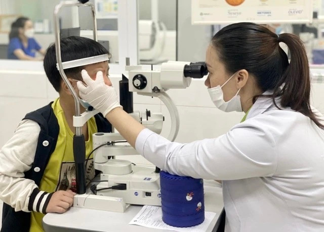 Bác sĩ khám bệnh đau mắt đỏ cho trẻ em. Ảnh: Trần Hiếu