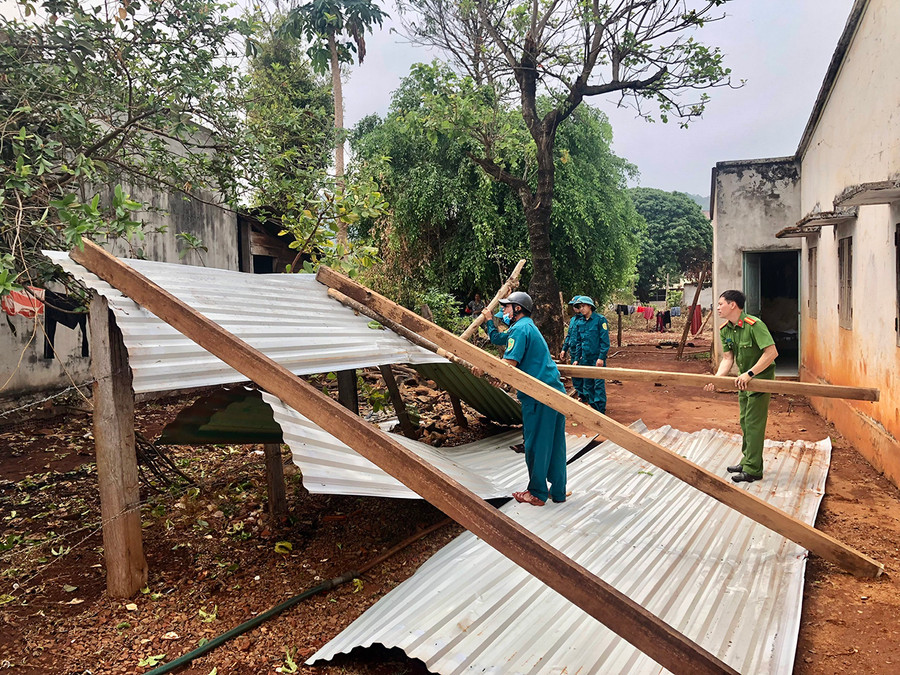 Lực lượng Công an xã, Dân quân xã hỗ trợ gia đình ông Puih Klơn lợp lại mái nhà. Ảnh: Lê Nam Lực lượng Công an xã, Dân quân xã hỗ trợ gia đình ông Puih Klơn lợp lại mái nhà. Ảnh: Lê Nam