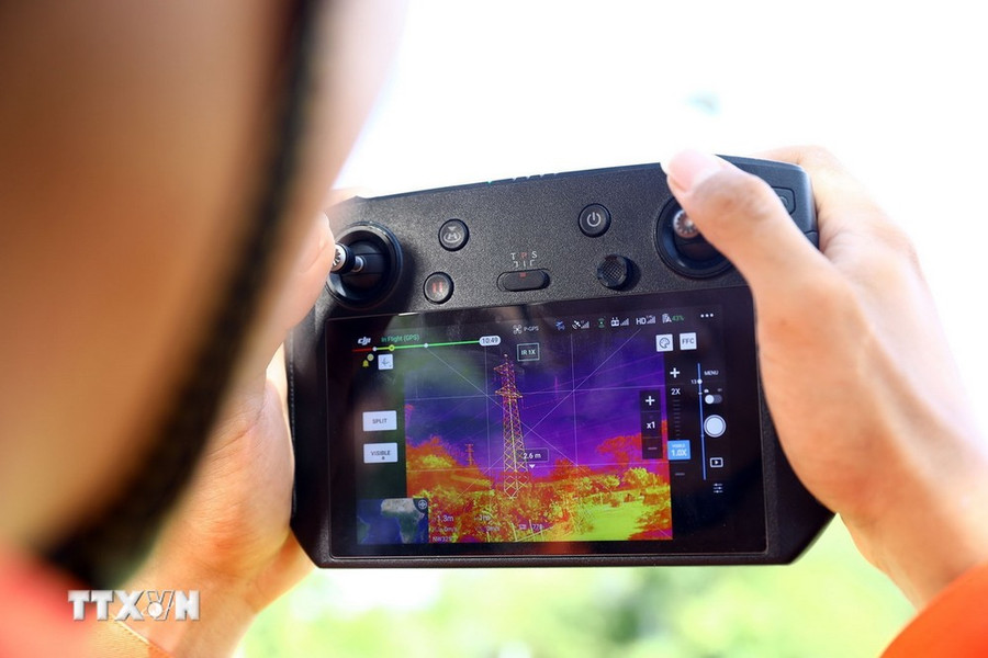 Công nhân Truyền tải điện Bình Định sử dụng thiết bị bay UAV có camera chụp ảnh nhiệt phục vụ công tác kiểm tra phát nhiệt thiết bị trên đường dây. (Ảnh: Huy Hùng/TTXVN) Công nhân Truyền tải điện Bình Định sử dụng thiết bị bay UAV có camera chụp ảnh nhiệt phục vụ công tác kiểm tra phát nhiệt thiết bị trên đường dây. (Ảnh: Huy Hùng/TTXVN)