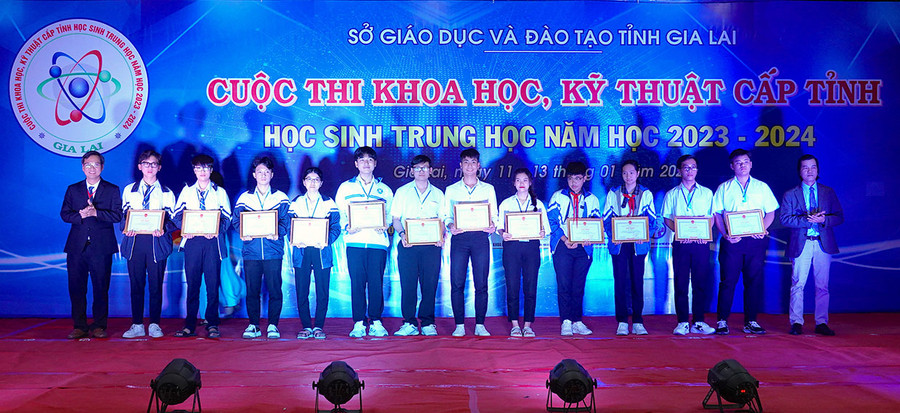 Hai em Ngô Hữu Gia Phước và em Nguyễn Mai Quang Minh (thứ 2 và 3 từ trái sang) nhận giải ba tại Cuộc thi Khoa học, kỹ thuật cấp tỉnh học sinh trung học năm học 2023-2024 cho dự án Safe Alert. Ảnh: Mộc Trà