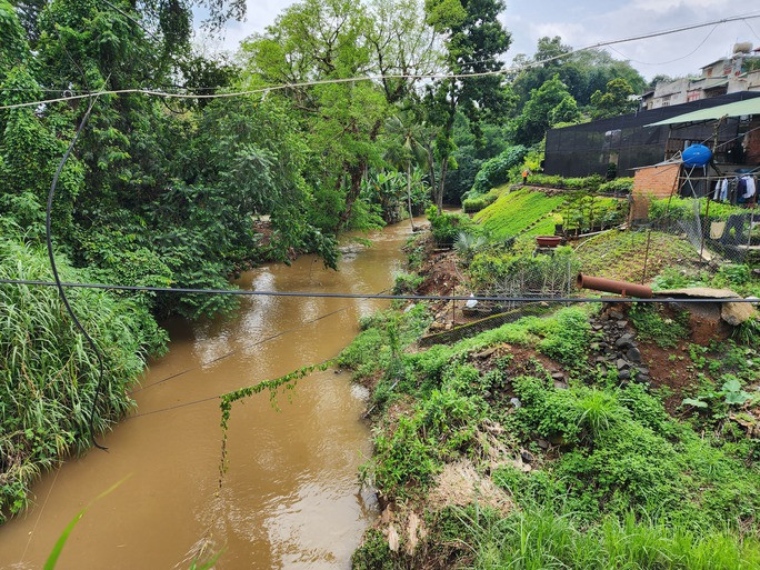 Xây thành phố xanh mang bản sắc riêng ở Tây Nguyên - Ảnh 2. Suối Ea Tam chảy giữa lòng thành phố nhiều đoạn bị biến dạng bởi tình trạng xây dựng nhà ở, bờ kè, tường chắn lấn chiếm, sẽ được cải tạo, chỉnh trang.