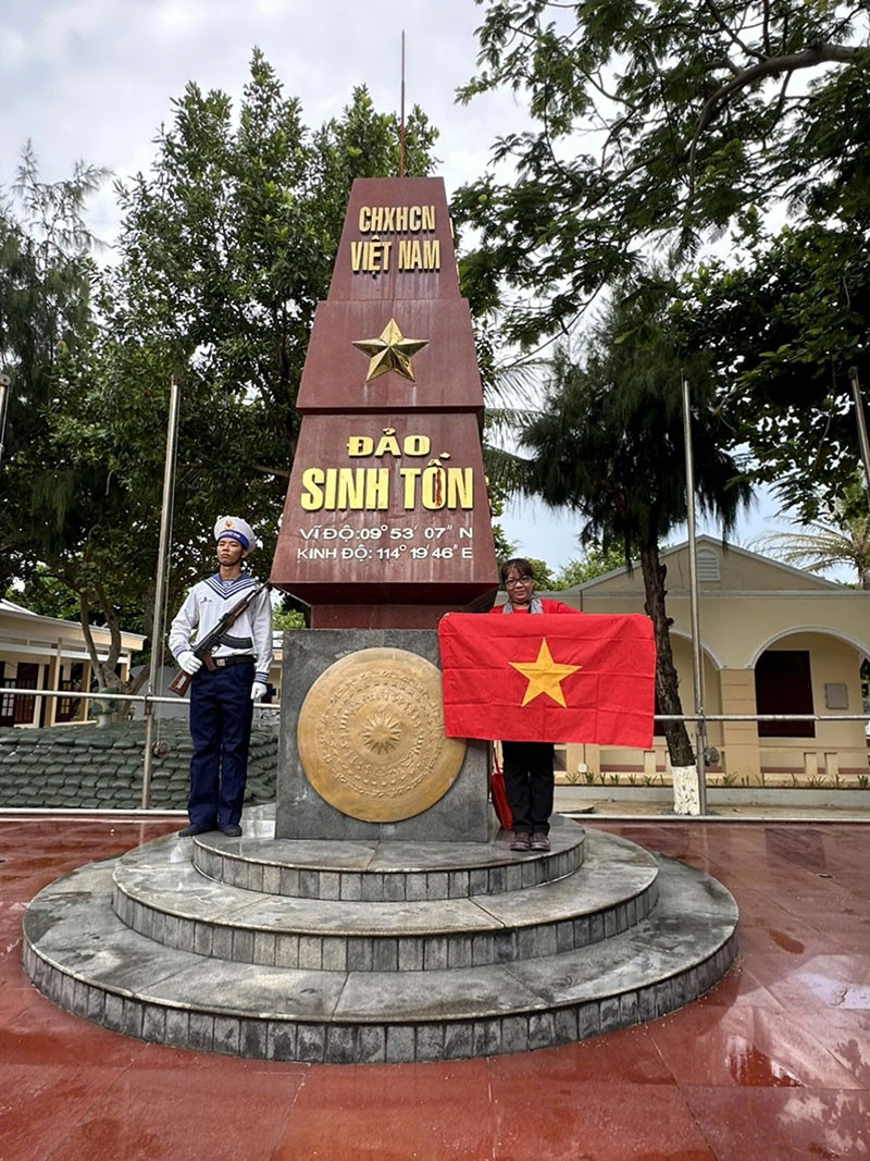 Tác giả chụp ảnh ở cột mốc đảo Sinh Tồn cùng lá cờ Tổ quốc. Tác giả chụp ảnh ở cột mốc đảo Sinh Tồn cùng lá cờ Tổ quốc.