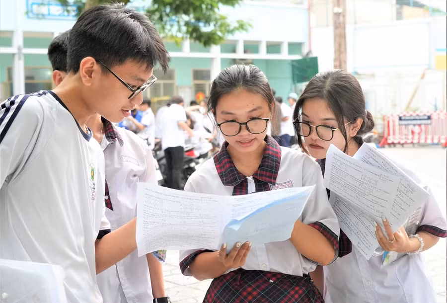 Thí sinh đối chiếu bài làm môn Toán sau giờ thi tại điểm thi Trường THCS Colette (quận 3, TPHCM). Ảnh: HOÀNG HÙNG