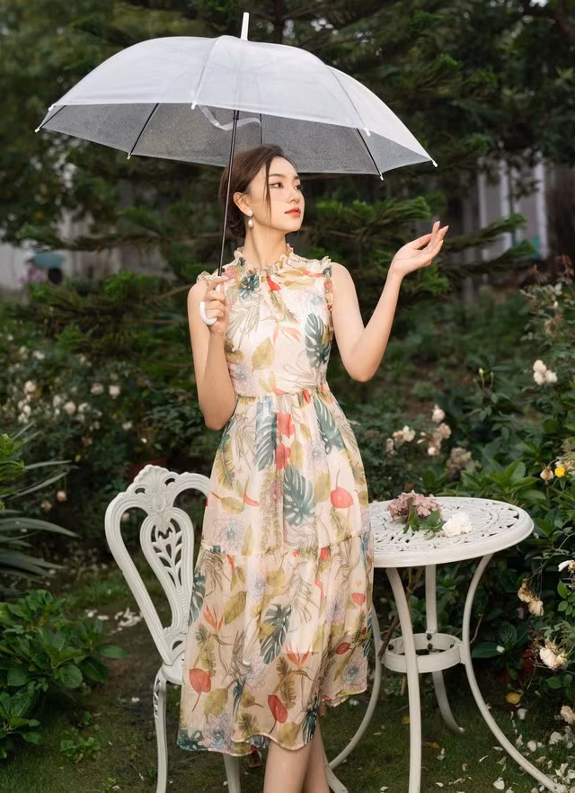 Trong những ngày mưa, đầm hoa vẫn luôn là sự lựa chọn số 1 của hội chị em. Với thiết kế sát nách, diềm bèo và chân váy tầng, tất cả đã tạo nên sự bồng bềnh, duyên dáng, đồng thời tôn lên vóc dáng và mang lại sự tự tin cho người mặc.