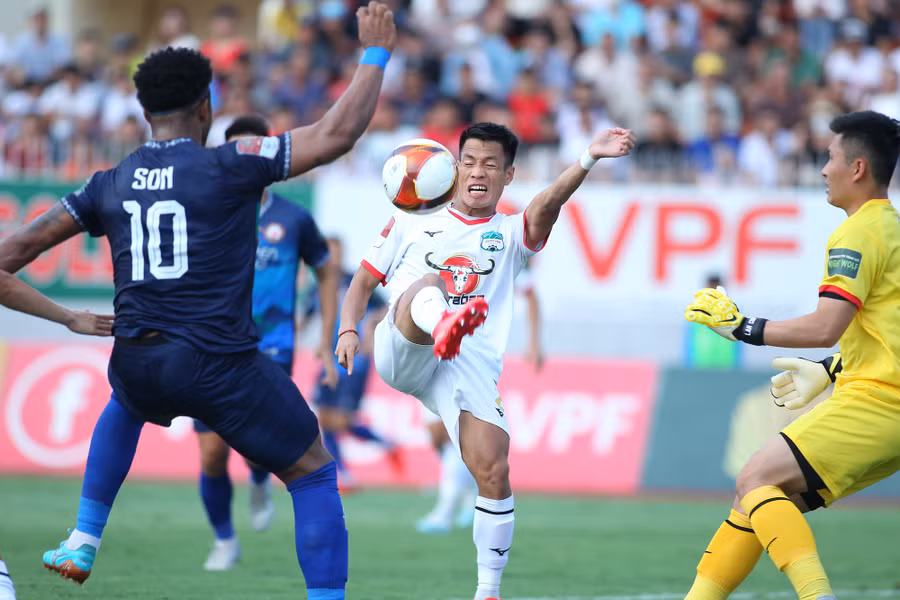 Hậu vệ HAGL Văn Sơn phá bóng trước sự áp sát của tiền đạo Rafaelson bên phía CLB Bình Định. Ảnh: Dũng Nguyễn