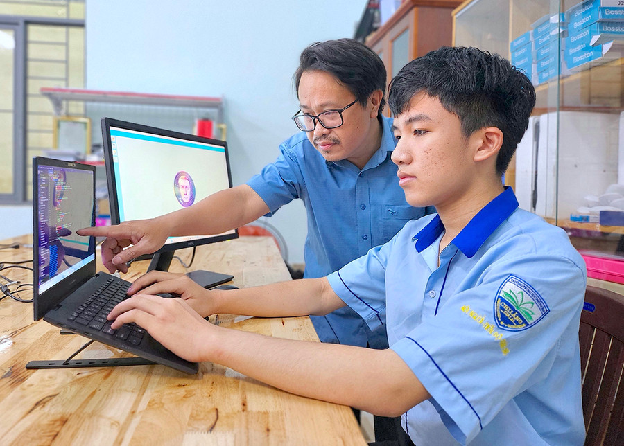 Em Võ Đăng Tuệ và thầy Đồng Ánh Dương (Trường THPT Chi Lăng, TP. Pleiku) trong một giờ học lập trình. Ảnh: M.T Em Võ Đăng Tuệ và thầy Đồng Ánh Dương (Trường THPT Chi Lăng, TP. Pleiku) trong một giờ học lập trình. Ảnh: M.T