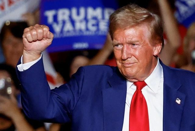 Ông Trump giơ nắm đấm trong cuộc mít tinh tại bang Nevada hôm 13.9. ẢNH: REUTERS