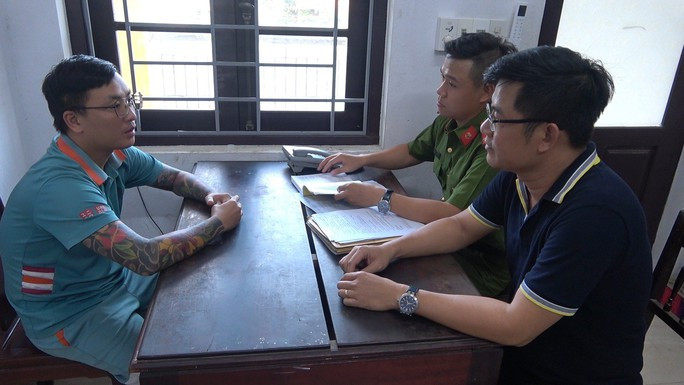 Công an làm việc với Nguyễn Đức Tài (trái)