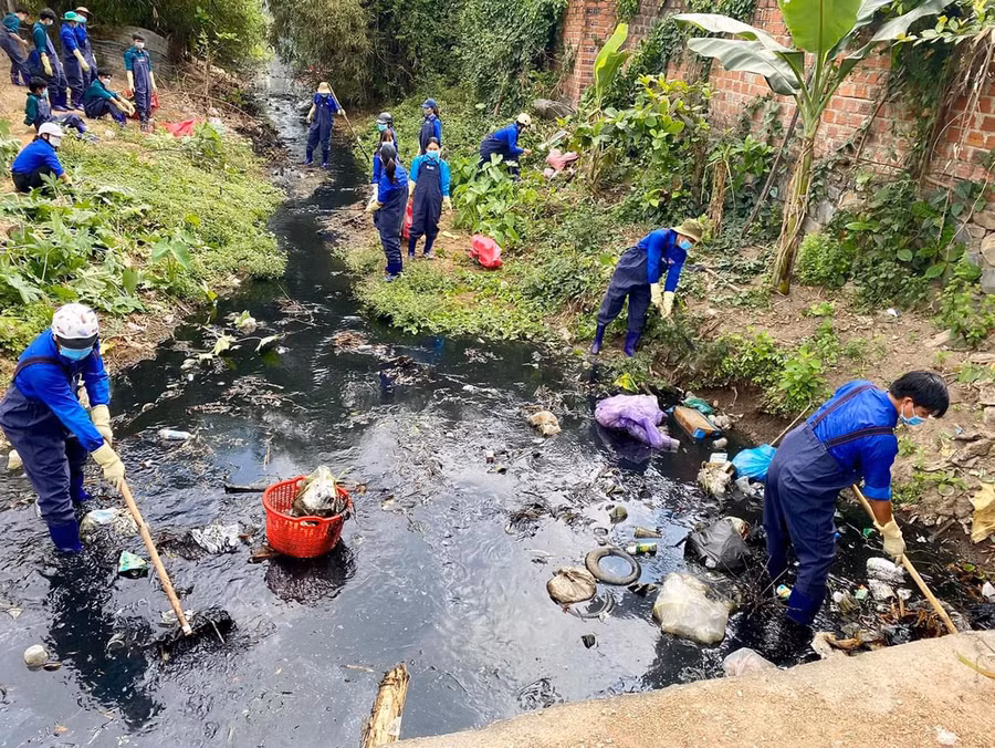 Các thành viên của nhóm Krông Pa Xanh khơi thông dòng chảy tại suối Cầu 1 (thị trấn Phú Túc, huyện Krông Pa). Ảnh: Mai Thanh