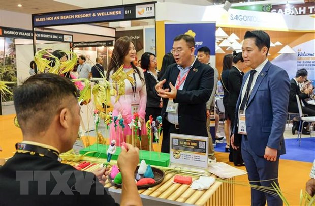 Ông Poh Chi Chuan (giữa), Giám đốc Điều hành Phụ trách Triển lãm và Hội thảo của Ủy ban Du lịch Singapore, thăm gian hàng của Việt Nam. (Ảnh: Lê Dương/TTXVN)