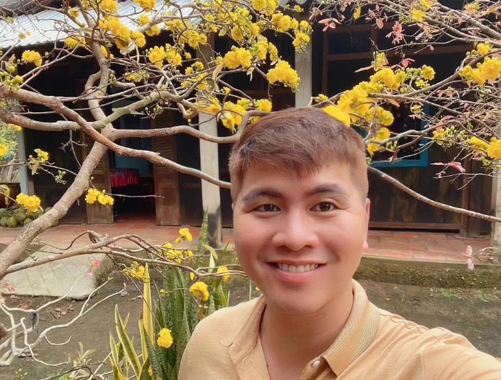 Quốc Thông chụp hình với cây mai 150 cánh vào tết năm trước. Ảnh: NVCC