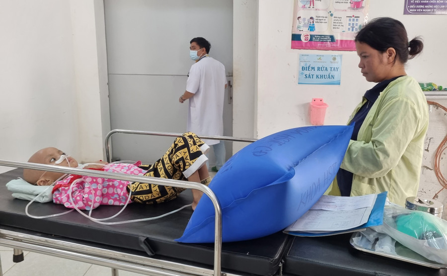 Chị Rơ Châm Pin chăm sóc Rơ Châm Bùi Thảo Linh tại Bệnh viện Nhi tỉnh. Ảnh: H.P