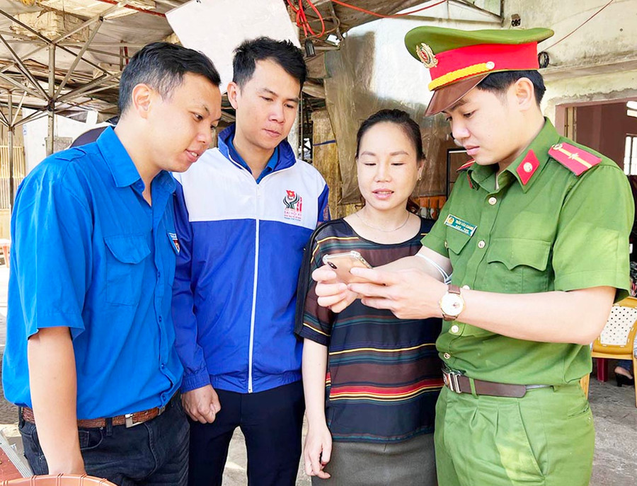 Đoàn viên, thanh niên phường Hội Thương (TP. Pleiku) hướng dẫn người dân cài đặt ứng dụng và tuyên truyền về mô hình “Tổ dân phố điện tử”. Ảnh: Phan Lài