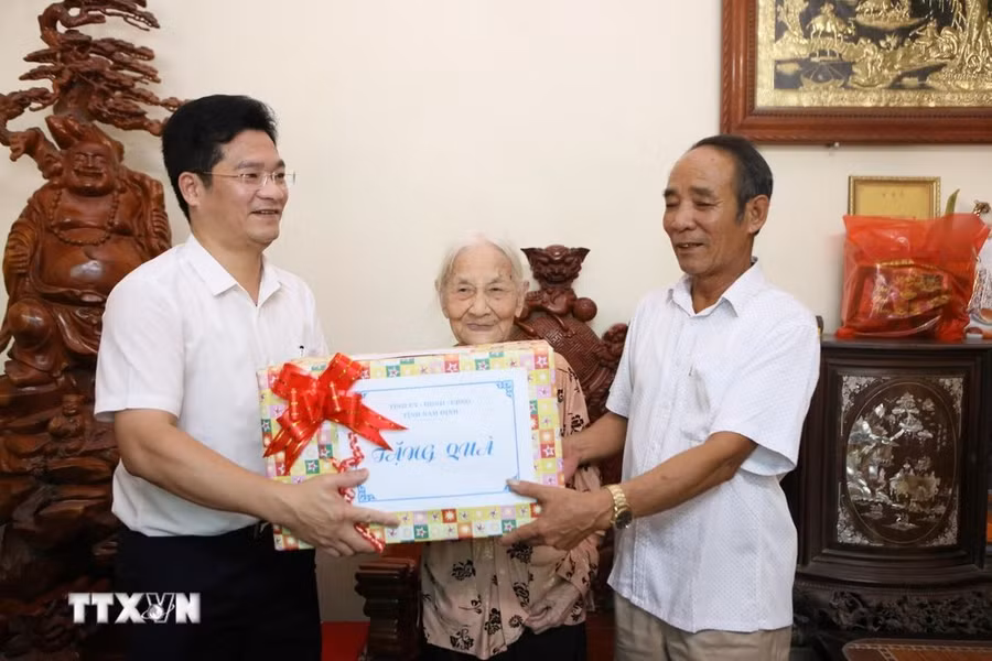 Phó Chủ tịch Thường trực UBND tỉnh Nam Định Trần Anh Dũng tặng quà cho Bà mẹ Việt Nam Anh hùng Trần Thị Chúc, sinh năm 1925, tại xã Mỹ Thắng. (Ảnh: Công Luật/TTXVN)