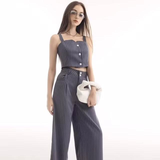 Nếu làm việc trong môi trường không quá khắt khe, bạn hãy thử "đổi gió" với set đồ co-ords họa tiết kẻ sọc dọc cổ điển gồm áo hai dây crop top và quần ống rộng cạp cao