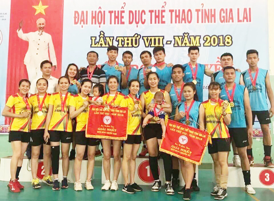 Anh Bảo Hùng (ngoài cùng bên trái hàng trên cùng) với vai trò huấn luyện viên đã giúp đội bóng chuyền nam và nữ TP. Pleiku giành 2 tấm huy chương vàng tại Đại hội Thể dục thể thao toàn tỉnh năm 2018. Ảnh: Văn Ngọc