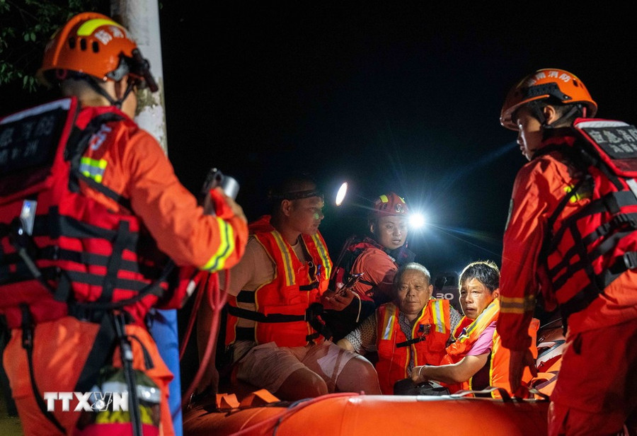 Lực lượng cứu hộ sơ tán người dân tại khu vực bị ảnh hưởng sau sự cố vỡ đê sông Juanshui ở huyện Tương Đàm, tỉnh Hồ Nam, Trung Quốc, ngày 29/7/2024. (Ảnh: THX/TTXVN)