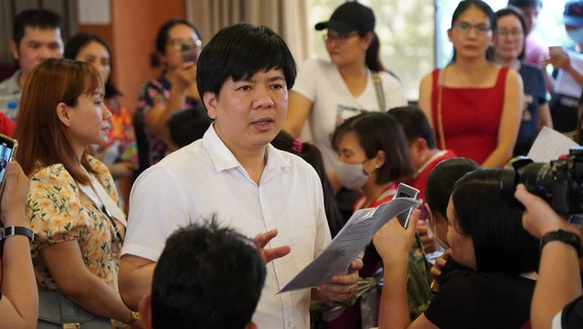 Ông Nguyễn Ngọc Thủy đọc lộ trình hoàn học phí trước hàng trăm phụ huynh TP.HCM tại cuộc họp cuối cùng ở miền Nam vào tháng 4.2023. ẢNH: NGUYỄN ANH