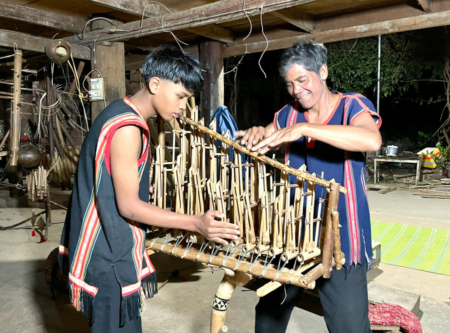 Nghệ nhân Ưu tú Rơ Châm Tih dạy con trai cách chơi đàn Klek Klok. Ảnh: Phương Duyên Nghệ nhân Ưu tú Rơ Châm Tih dạy con trai cách chơi đàn Klek Klok. Ảnh: Phương Duyên