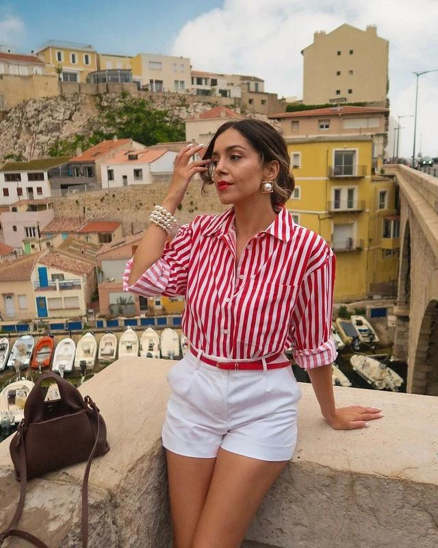 Gam màu hồng đỏ rạng rỡ và tươi sáng càng thêm nổi bật khi được phối cùng tông màu trắng. Ngoài quần shorts, hãy thử nghiệm phối chiếc áo này cùng quần denim trắng lưng cao hoặc chân váy trắng. Ảnh CELIA BRUNETTE